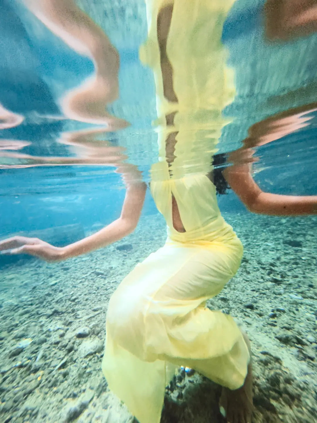 Person wearing a yellow dress underwater